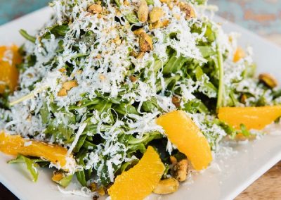 alt=" An italian salad featuring fruit, cheese, nuts and spinach"