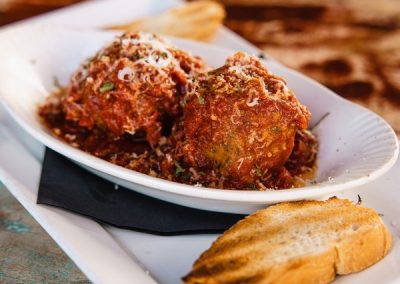 alt=" A plate of meatballs with toasted bread on the side"