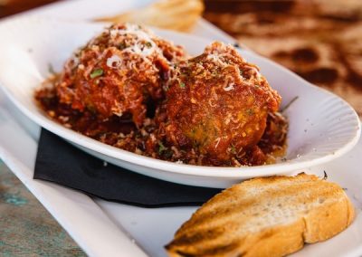 alt=" A plate of meatballs with toasted bread on the side"